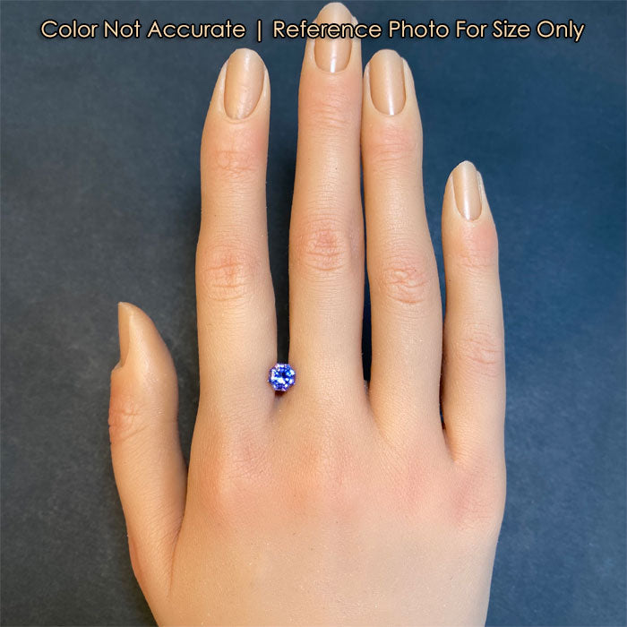 blue violet octagonal brilliant tanzanite gem on hand