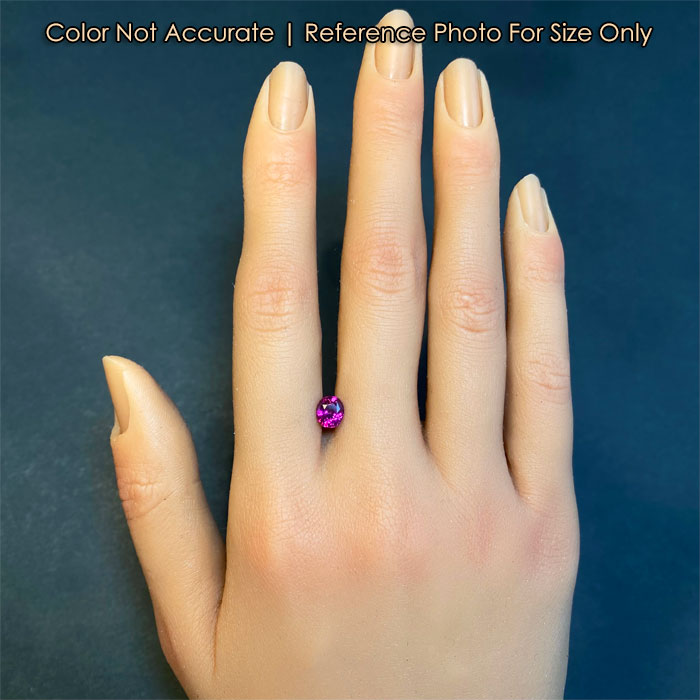 violet red ruby gem on hand