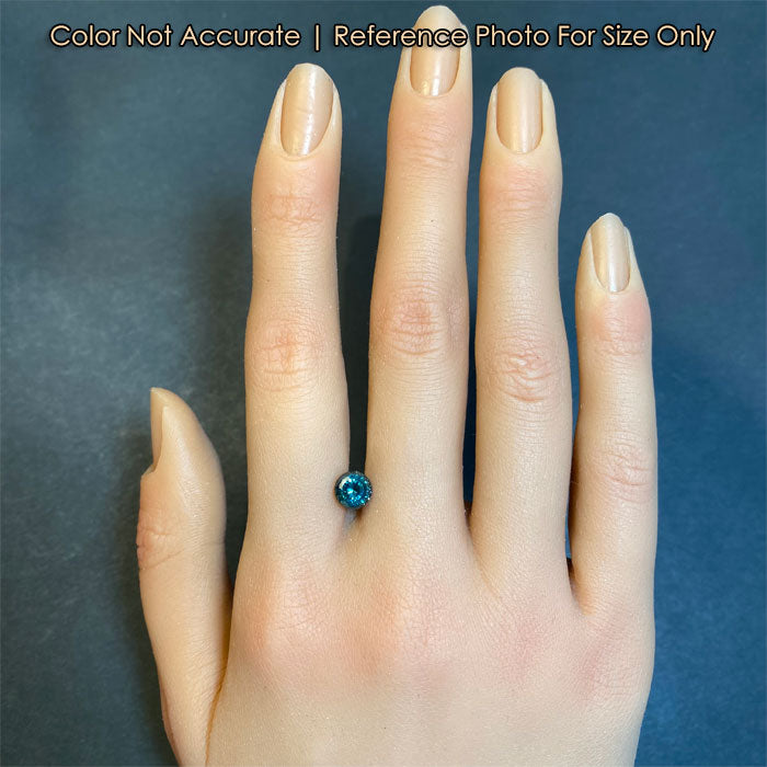 round portuguese blue green montana sapphire gem on hand size