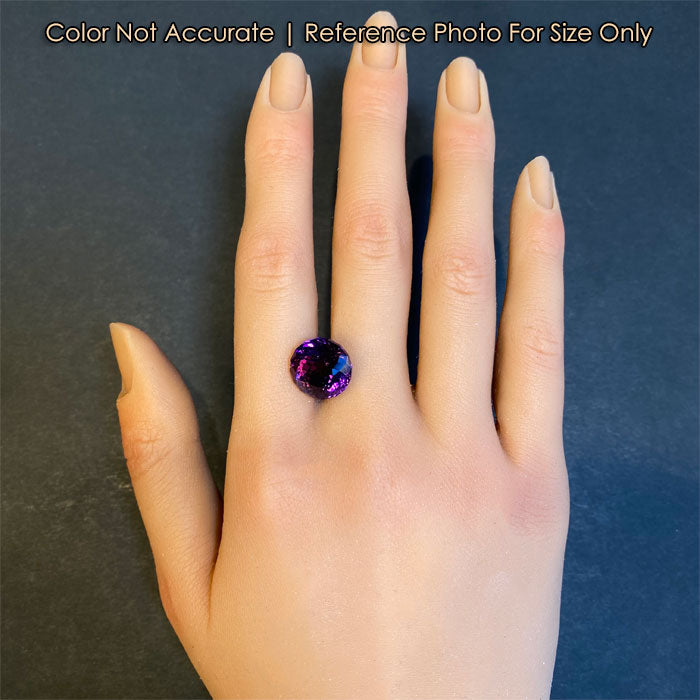 Round amethyst gem on hand