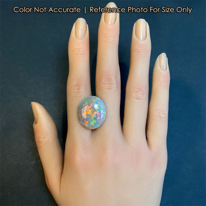 oval cabochon opal gem on hand for size