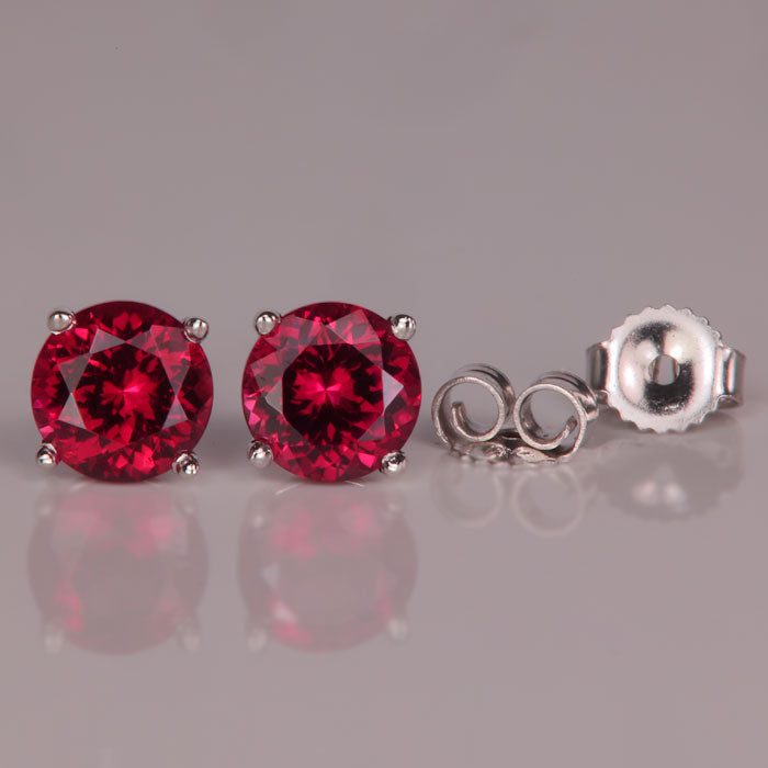 round brilliant rhodolite garnet stud earrings in white gold