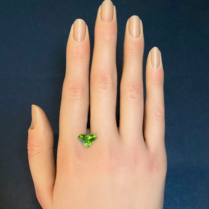 stepped shield cut peridot gem