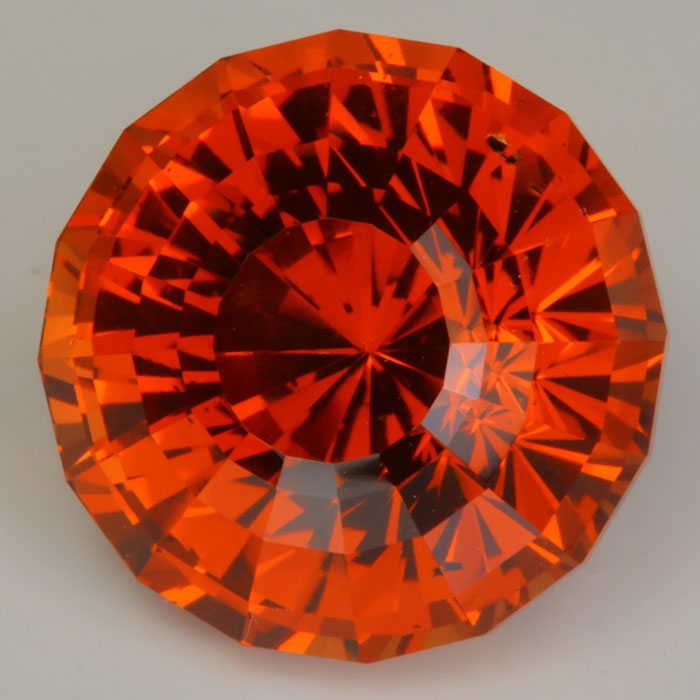 pinkish red orange garnet gemstone round step cut