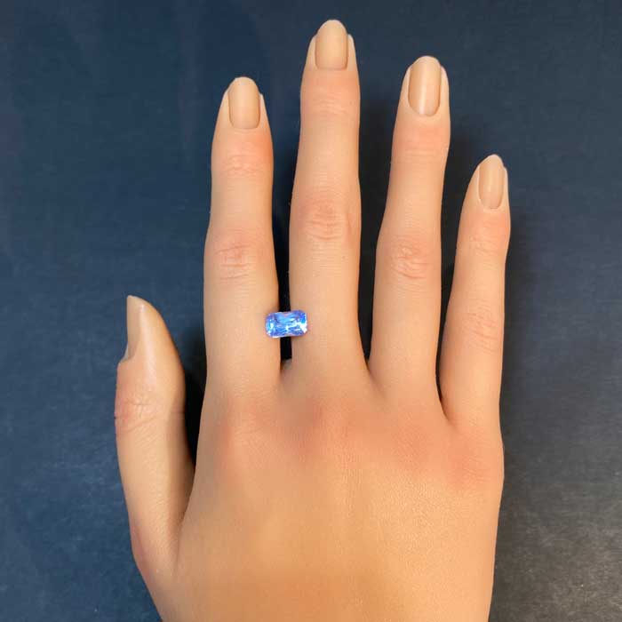 light blue sapphire gem on hand