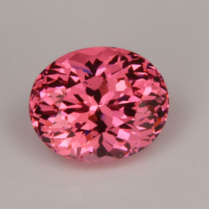 peachy pink oval cut garnet gemstone