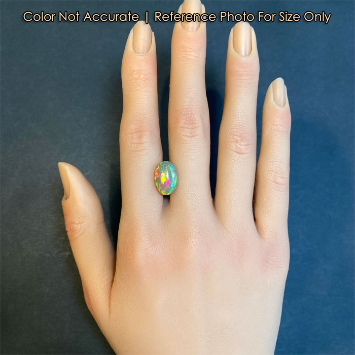 oval opal gem on hand