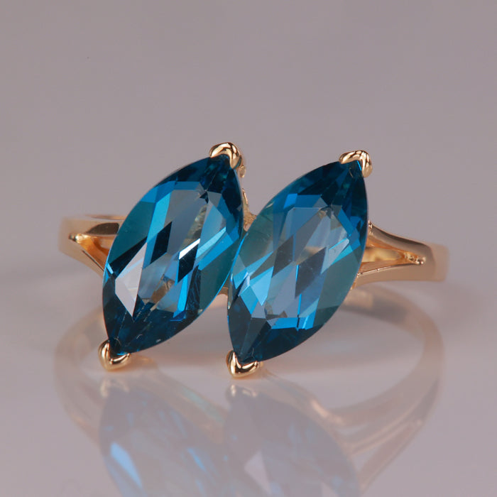 greenish blue marquise cut topaz gemstone ring in yellow gold