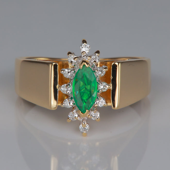 marquise cut emerald and diamond ring in yellow gold
