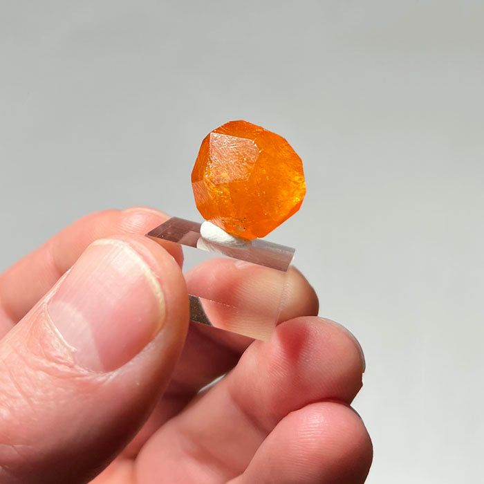 natural raw garnet in hand
