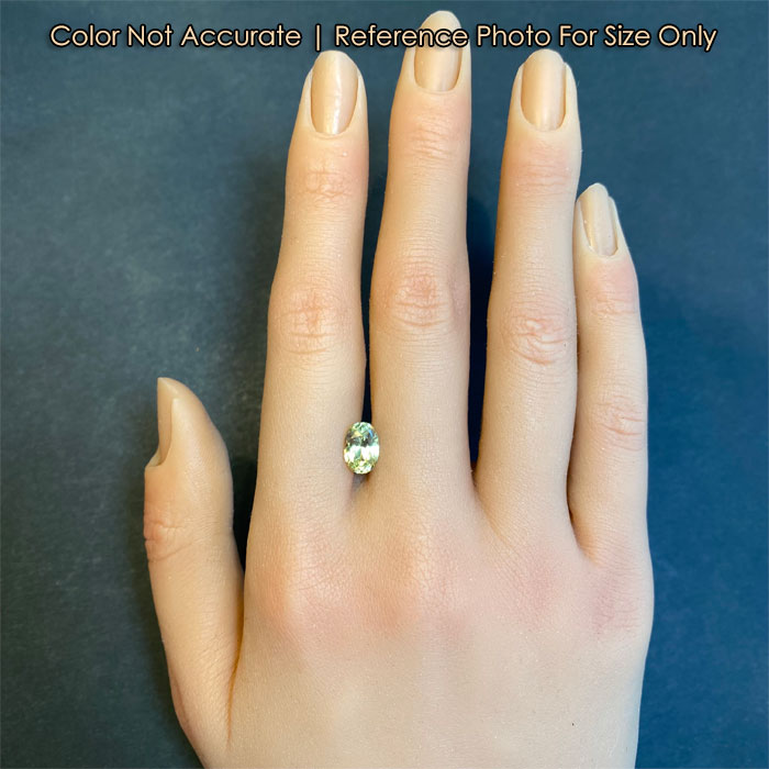 oval cut green yellow sapphire on hand size