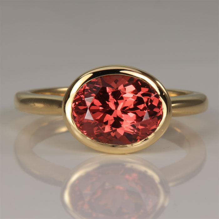 Oval Mahenge Malaya Garnet Bezel Set ring in 14k yellow gold