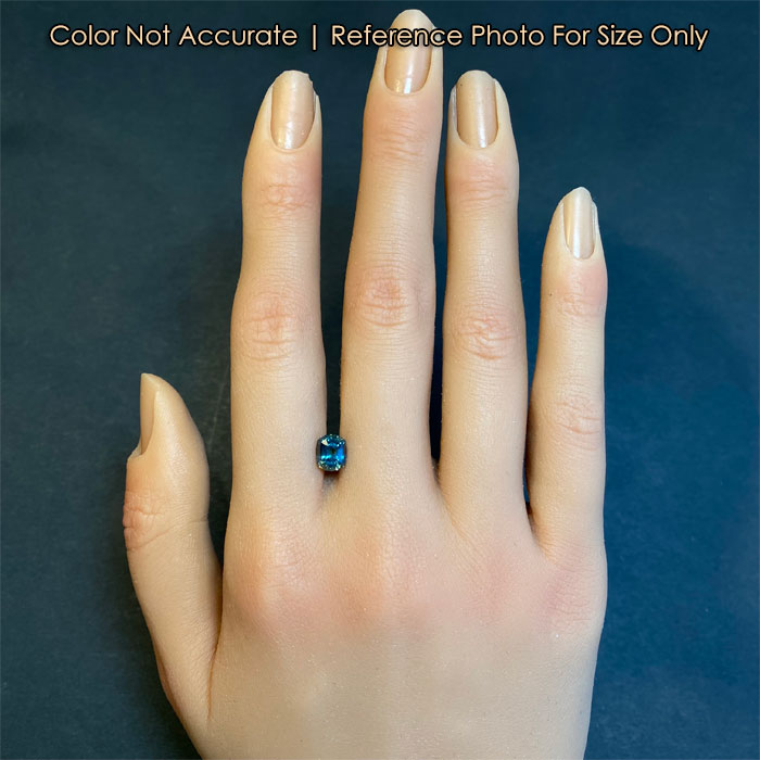 blue green montana sapphire on hand