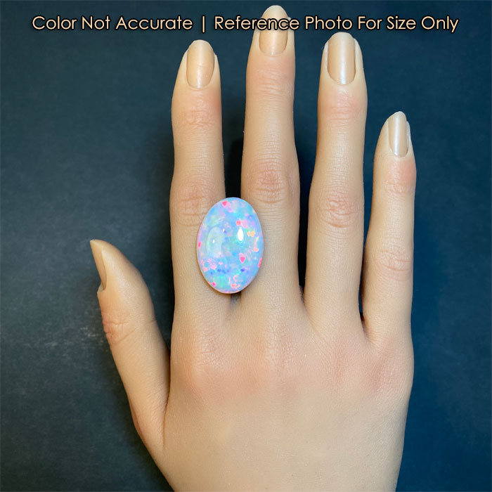 oval cabochon opal gem on a hand