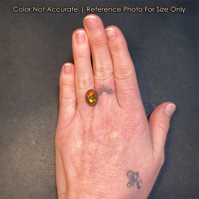 black opal gem on hand