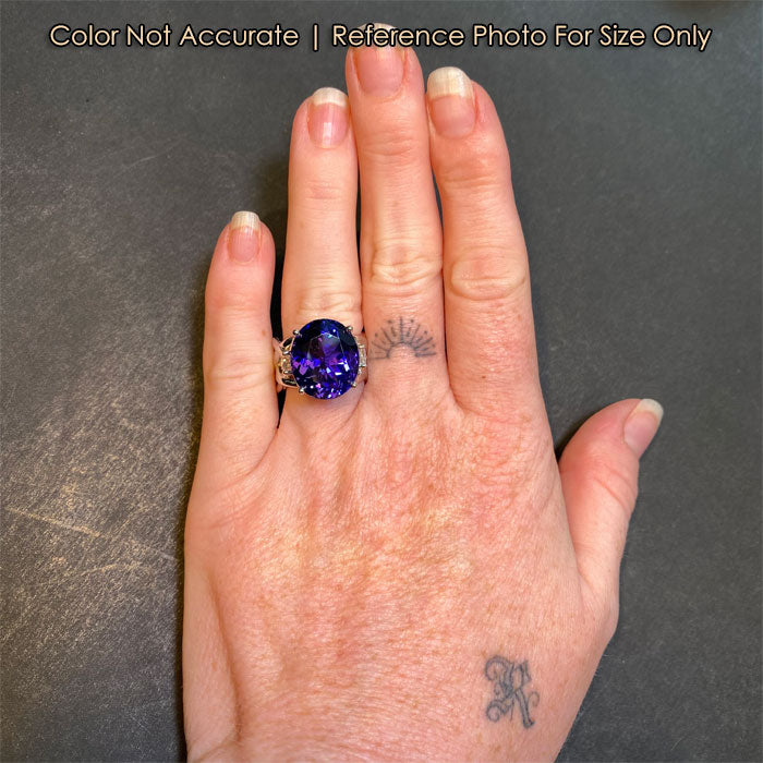 large oval tanzanite ring on hand