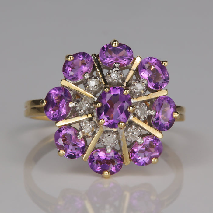 oval cut purple amethyst gemstones and diamonds in yellow gold ring