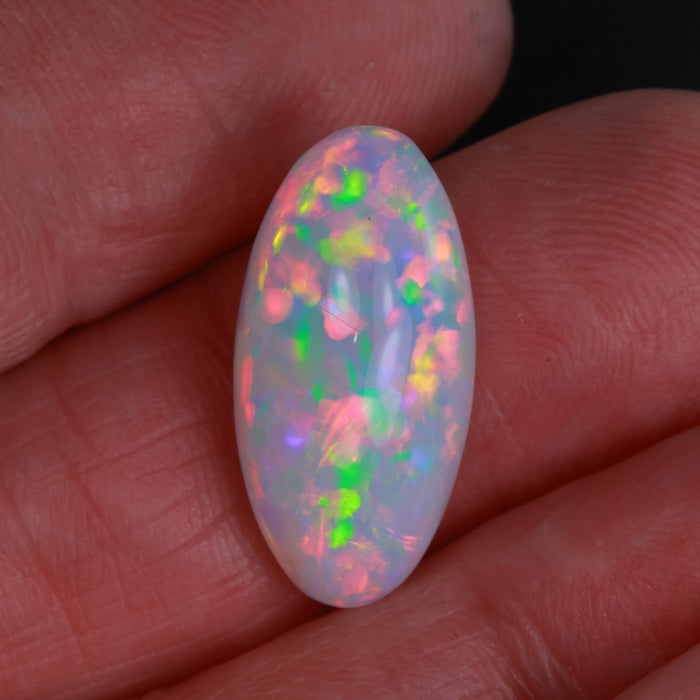 colorful opal gemstone in hand