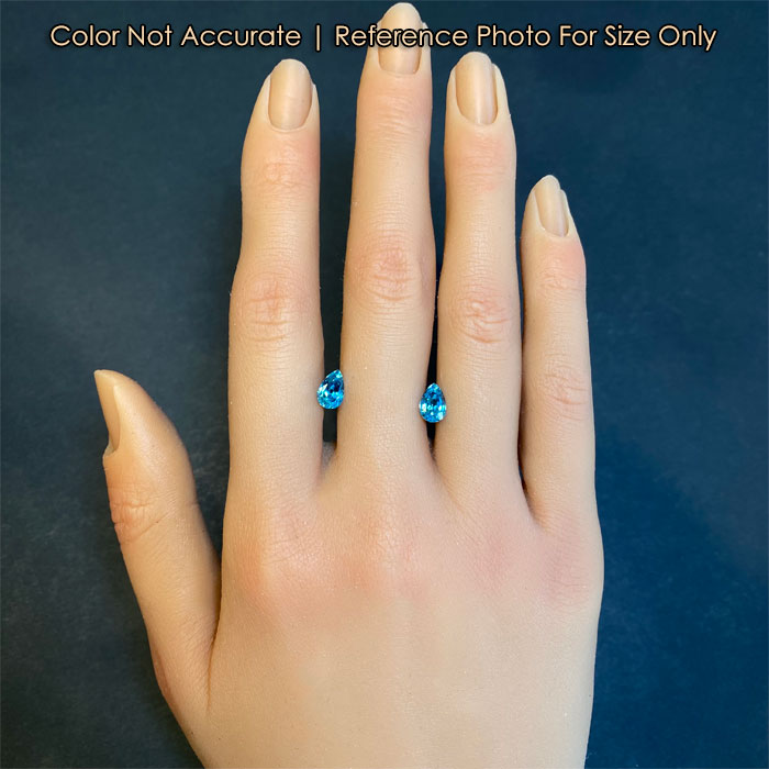pear shape blue zircon gemstones on hand