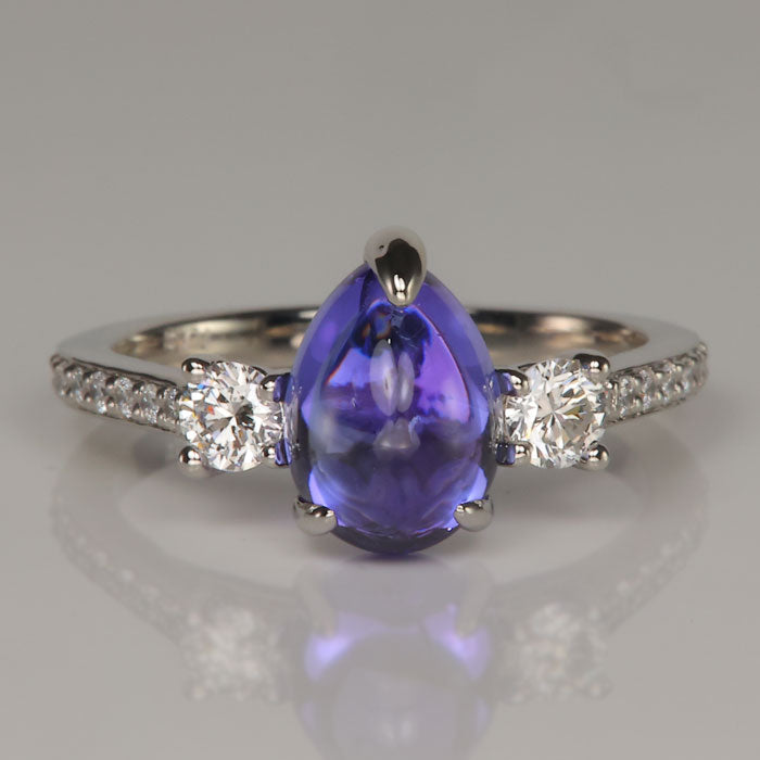 blue violet pear shape cabochon cut tanzanite ring with diamonds