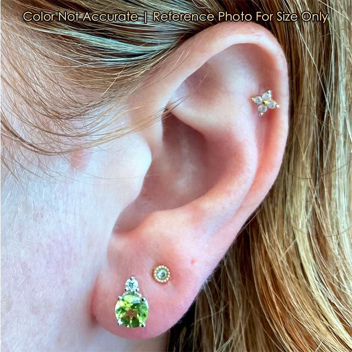peridot stud earrings on ear