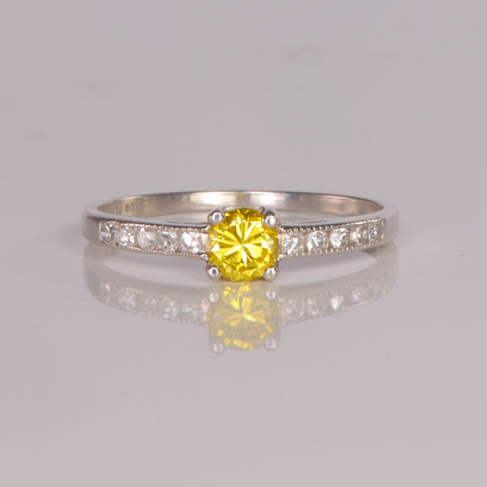 yellow diamond and fine diamond ring in platinum