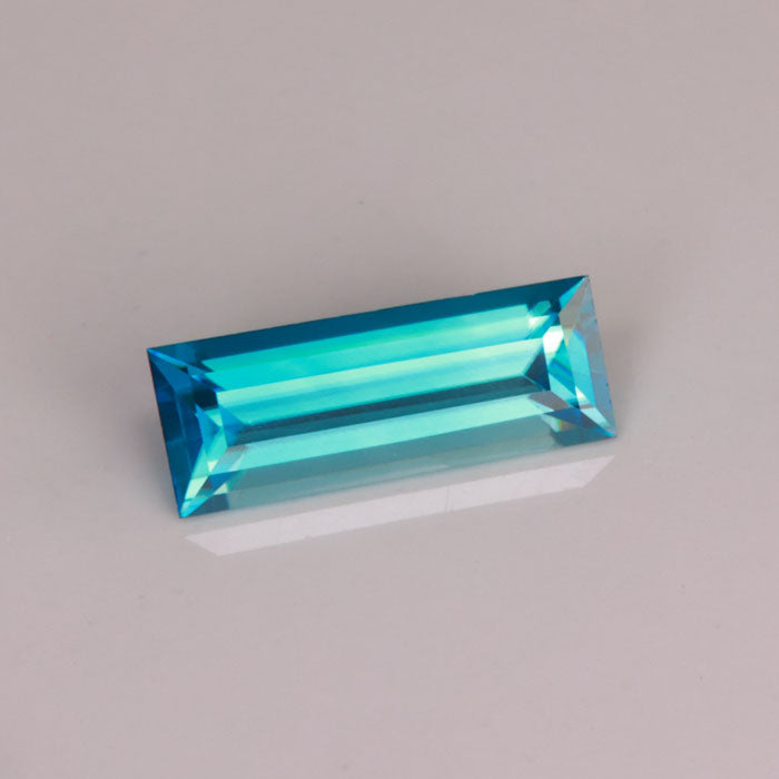greenish blue rectangular step cut blue zircon gemstone