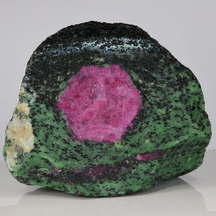 green zoisite mineral with violet red ruby