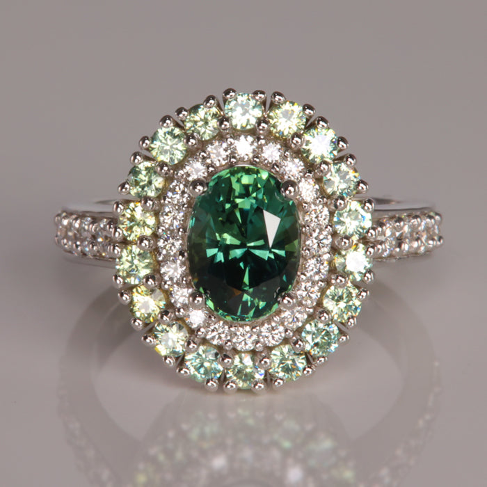 blue green sapphire gemstone ring with diamond and demantoid garnet accents in white gold