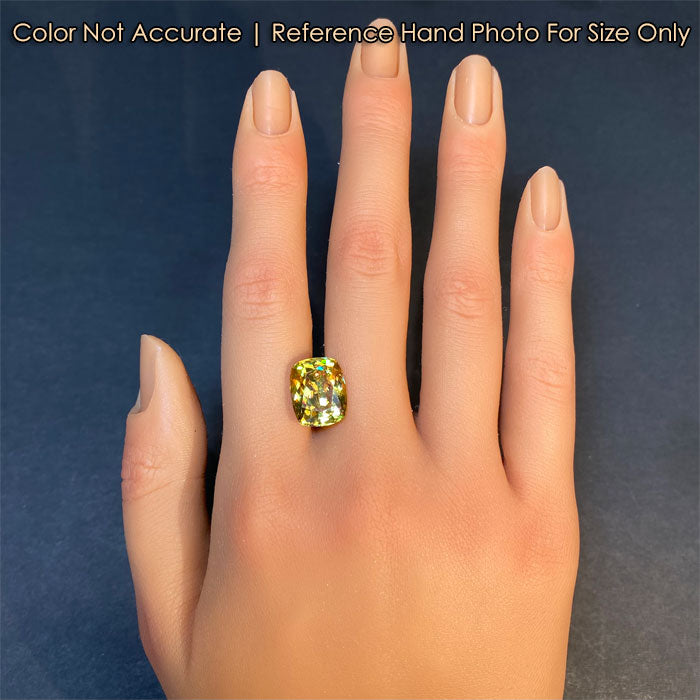 greenish yellow sphene gem on hand