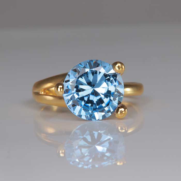 blue synthetic spinel ring in yellow gold