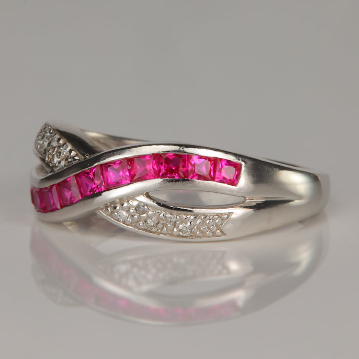 white gold ring with diamond accents and synthetic ruby