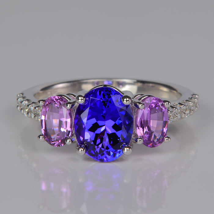 oval tanzanite gemstone with oval pink sapphires in a white gold ring with diamonds