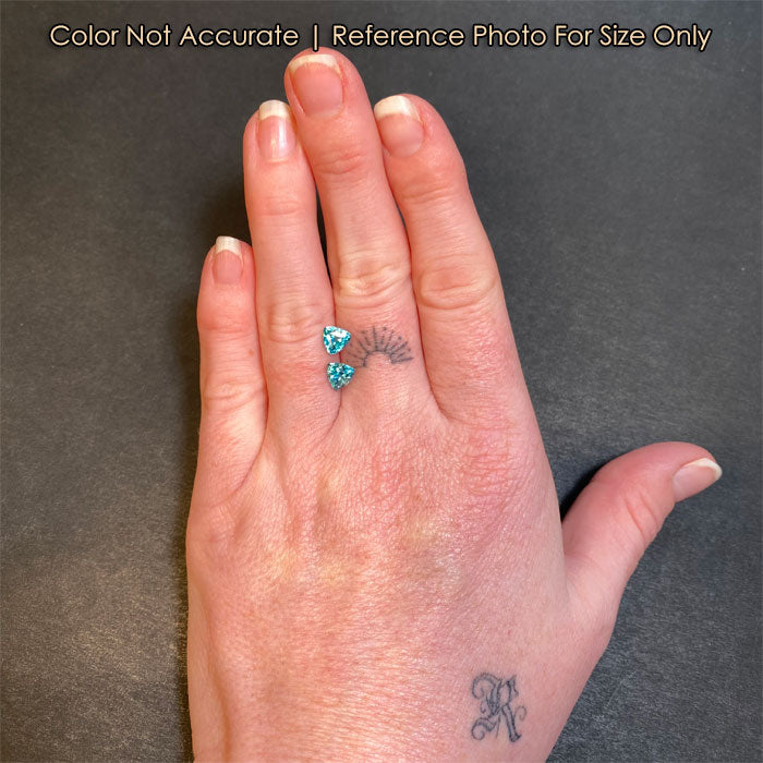 size of two trilliant zircon gems to hand