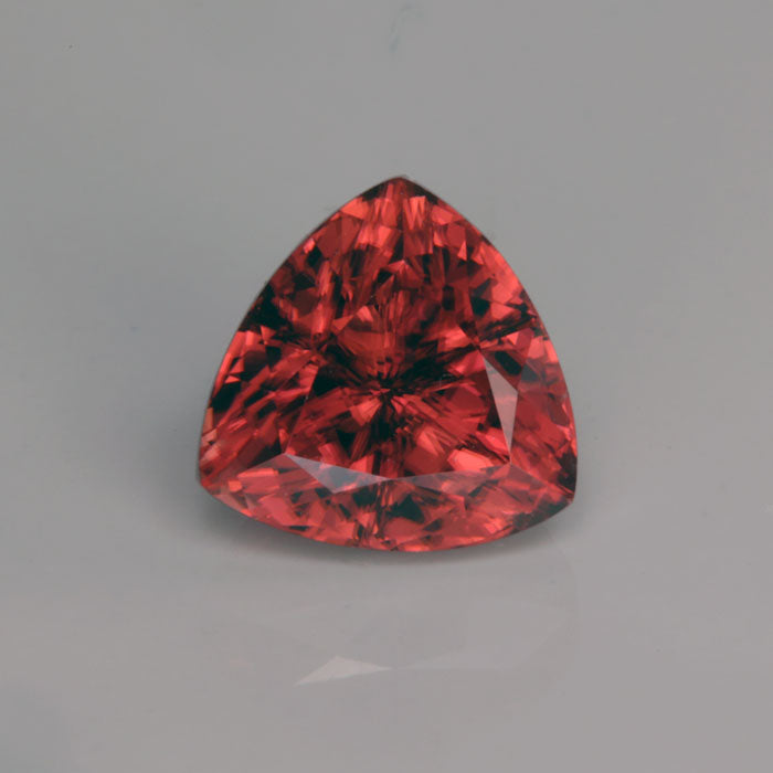 trilliant cut peachy red zircon gemstone