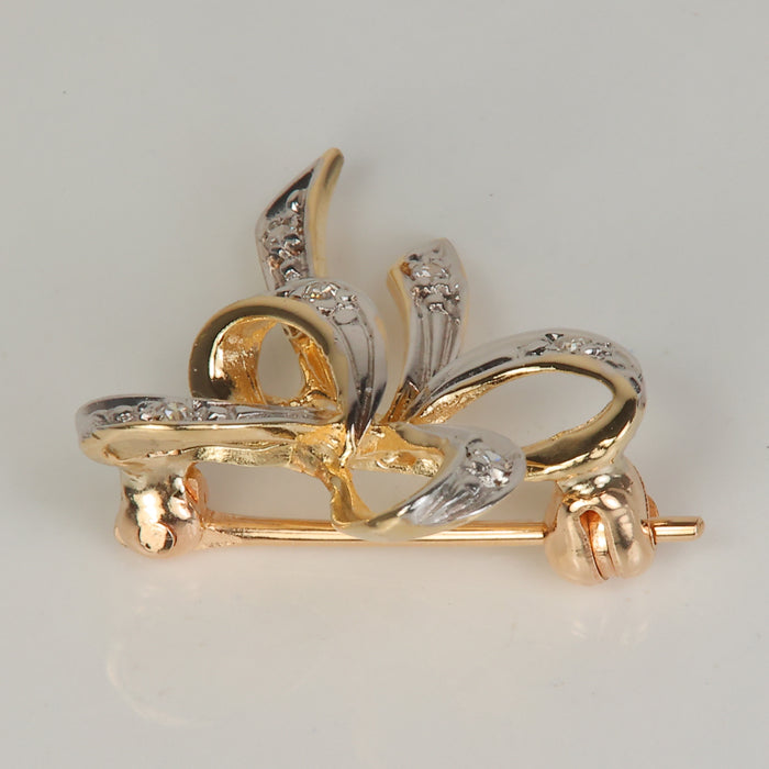 bow pin in yellow gold with diamonds