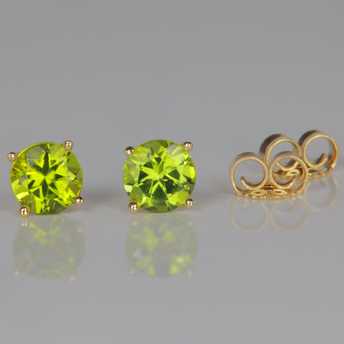 green peridot gemstone studs in yellow gold