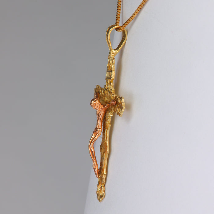 gold and rose gold pendant with crucifix