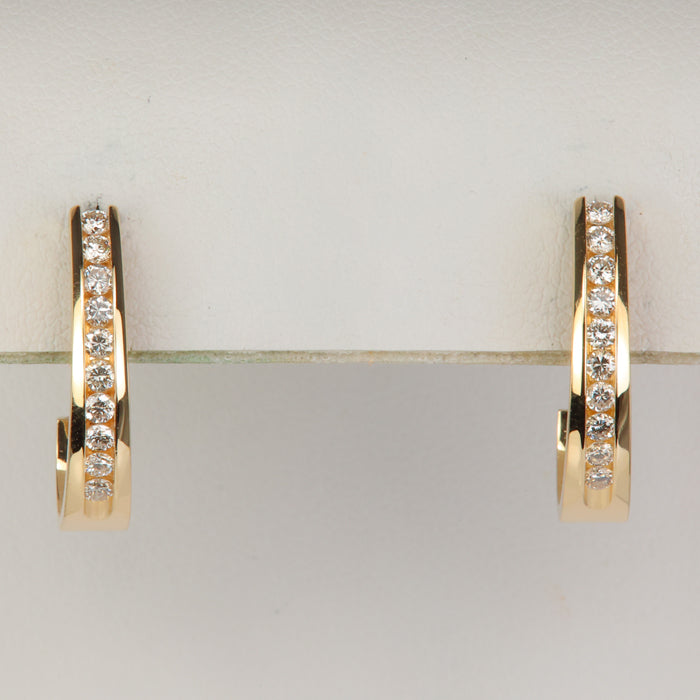 round brilliant channel set diamond earrings in yellow gold