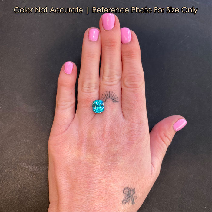 blue zircon gemstone on hand size