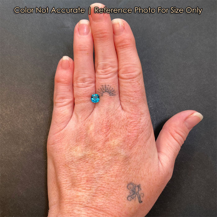 greenish blue zircon on hand