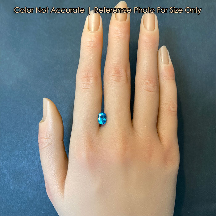 size reference of blue zircon gemstone to hand