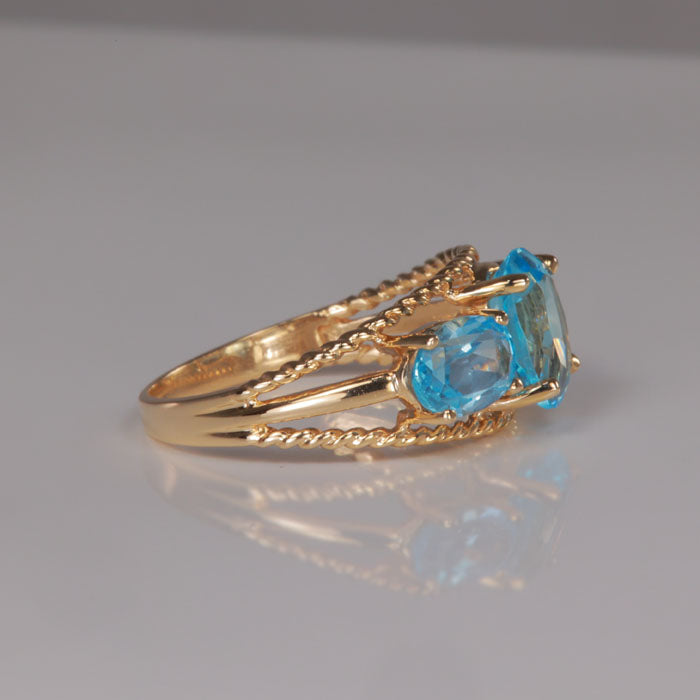 yellow gold ring with blue topaz gems