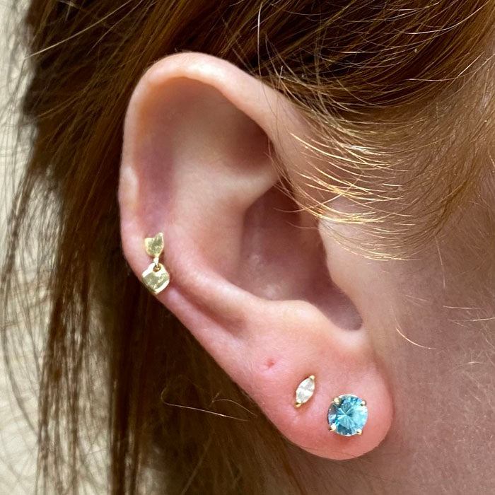 round cut blue zircon stud earrings yellow gold