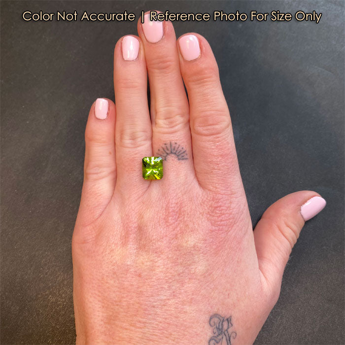 green color peridot gem on hand