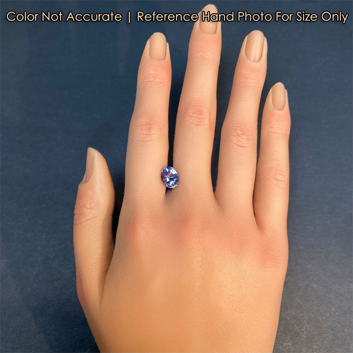 oval cut gray spinel on hand