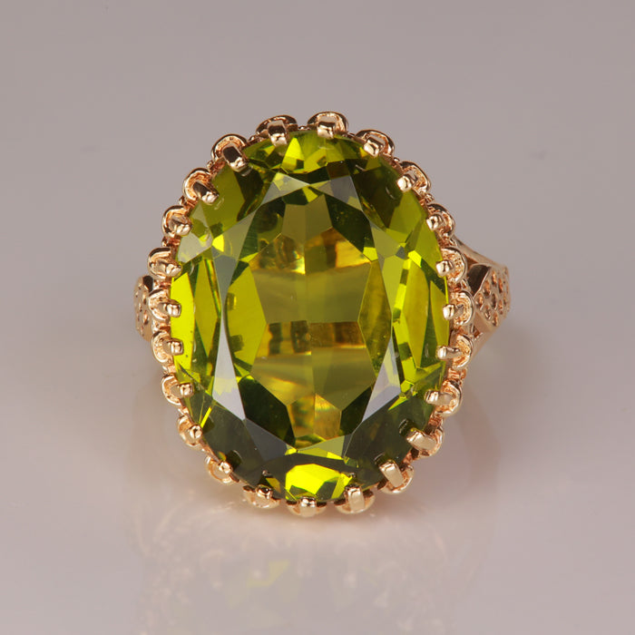 oval cut green color synthetic spinel gemstone ring in yellow gold