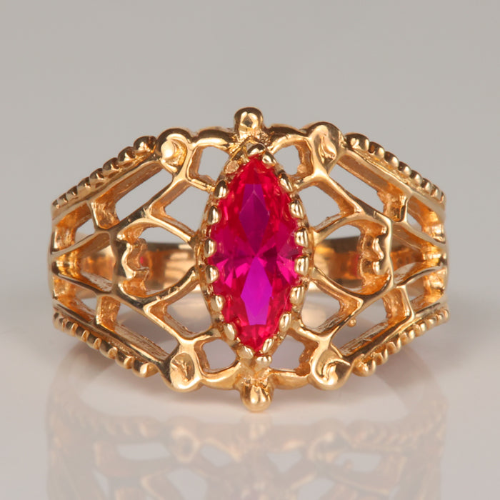 yellow gold ornate detail ring with marquise cut synthetic ruby