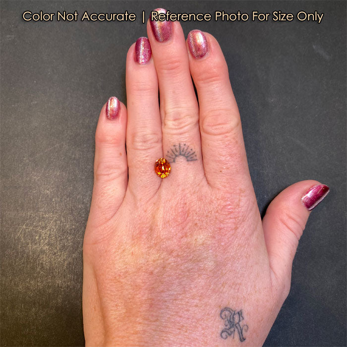 orange garnet gemstone on hand size