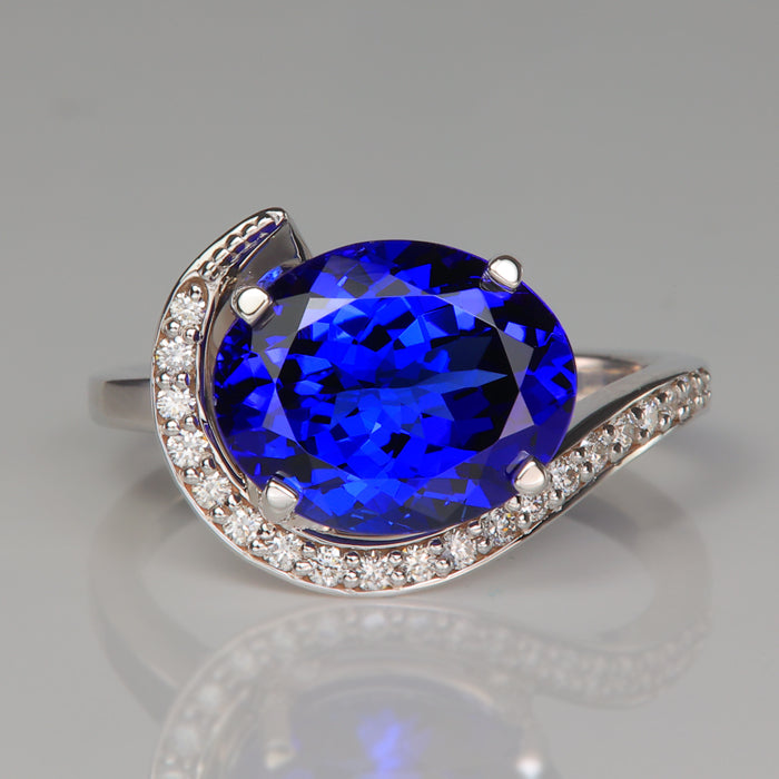white gold ring with mostly blue oval tanzanite gemstone and diamonds